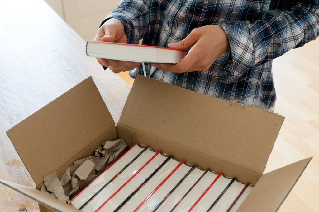 Author receiving copies of published book